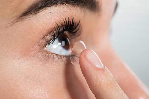 Person placing a contact lens