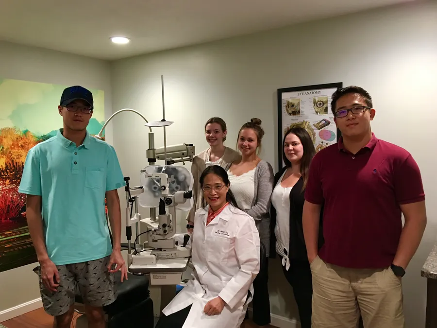 The HB Eye Care team with Dr. Xu and patients